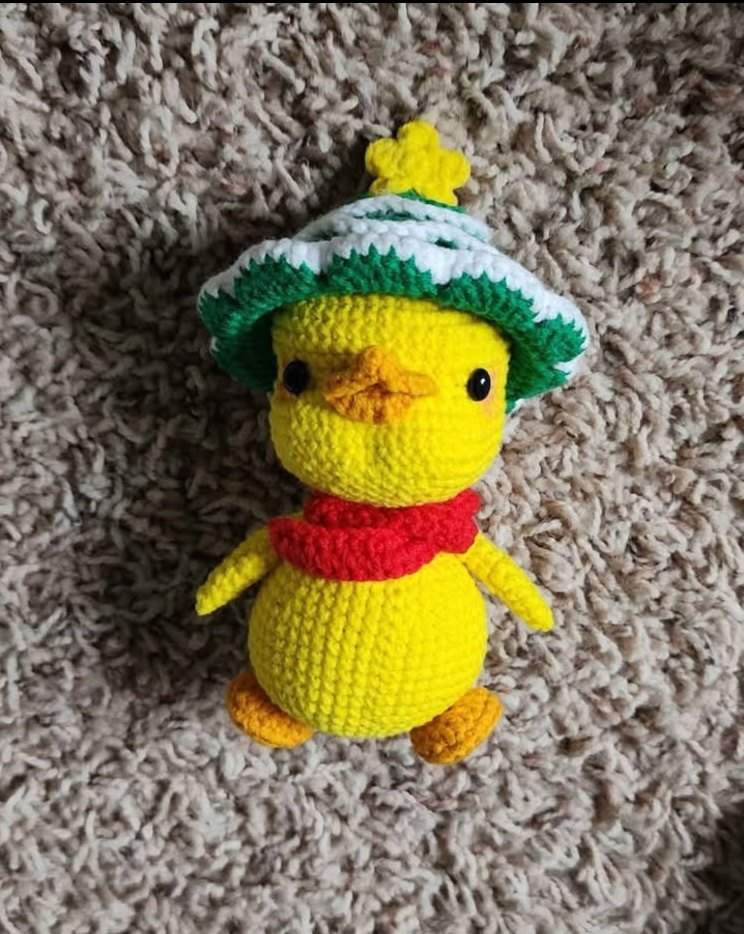 Ducky, a yellow crochet duck in a Christmas-tree hat